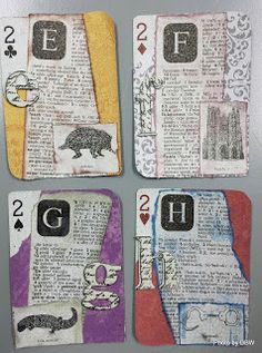 four playing cards with animals and letters on them, all made out of newspaper paper