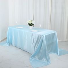 a blue table cloth on top of a white table