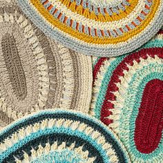 crocheted rugs are arranged on top of each other