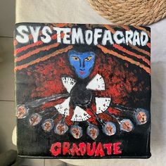 a painting on the back of a chair that says sytemofacard graduate