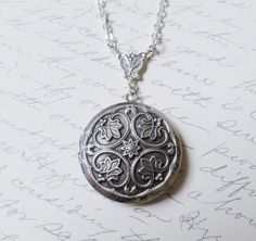 The antique silver plated floral engraved locket is 32mm. An antique silver Renaissance style pattern adorns the front of this locket. The locket is connected to a 24 inch chain by a rosary style connector. The locket is packaged in a lovely little silhouette box, set on a soft piece of white cotton.•••••••••••••••••••••••••••••••••••••••••••• ♥ • ♥ • ♥ • ♥ • ♥ • ♥ • ♥ • ♥ ••••••••••••••••••••••••••••••••••••••••••••••© Original design by Twilight's CastleThank you for visiting!Twilight's Castle Intricate Medallion Locket Necklace For Anniversary, Victorian Silver Locket Necklace For Anniversary, Victorian Etched Locket Necklace As Gift, Victorian Etched Locket Necklace For Gift, Victorian Etched Locket Necklace Gift, Etched Pendant Locket Necklace For Wedding, Vintage Silver Necklace For Anniversary Gift, Silver Medallion Necklace For Anniversary Gift, Victorian Filigree Round Locket Necklace