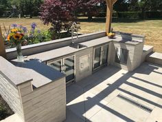 an outdoor kitchen that is built into the side of a house