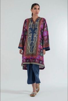 Introducing our stunning and chic two-piece kurta and pants set - a must-have addition to your wardrobe. Made from high-quality fabric, this set is designed for both comfort and style. The kurta features delicate details that add a touch of elegance to your look. The length of the kurta is just right, hitting just above the knees for a modern and sophisticated look.  The pants are designed in a straight leg style, featuring a comfortable and adjustable waistband for a perfect fit. The length is just right to complement the kurta, creating a cohesive and stylish outfit. Whether you're attending a wedding, Eid celebration, or simply want to elevate your everyday look, this set is perfect for any occasion. Pair it with your favorite accessories, shoes, and bag to create a complete look that w Elegant Jamawar Lawn Suit For Navratri, Designer Lawn Suit With Naqshi For Navratri, Elegant Purple Lawn Suit With Printed Motifs, Naqshi Cambric Kurta For Festivals, Purple Designer Lawn Suit With Straight Kurta, Unstitched Naqshi Salwar Kameez For Navratri, Festive Palazzo Set With Naqshi For Navratri, Festive Jamawar Lawn Suit Straight Kurta, Festive Naqshi Palazzo Set For Navratri