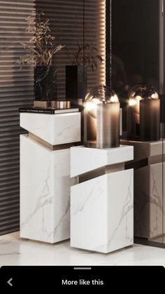 a white marble table topped with candles and vases