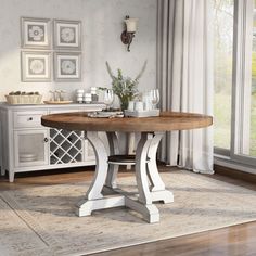 a dining room table and chairs in front of a window