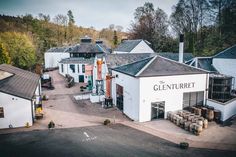 an aerial view of the clenturrett hotel and its surrounding buildings, with trees in the background