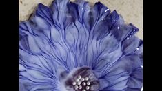 a blue flower sitting on top of a table