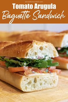 a close up of a sandwich on a cutting board with the words tomato arugula baguette sandwich