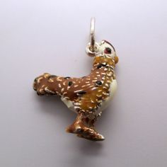 "This three-dimensional, sterling silver Rooster charm is hand-enameled and beautifully detailed. It features brown and black plumage, a white chest, tan neck, white head, black eyes, and a red cowl. Made by Brown County Silver. Vintage but in brand new, never worn condition. Charm height: 3/4\" high Charm height with ring: 1\" high Weight 4.2 grams See more @ https://www.etsy.com/shop/Brocosi" Brown Hallmarked Jewelry Gift, Brown Hallmarked Jewelry As Gift, Hallmarked Brown Jewelry As Gift, Brown County, White Chest, White Head, Sterling Silver Charms, Bird Charm, Food Jewelry