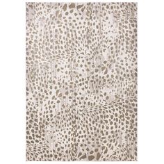 a white and brown rug with spots on it