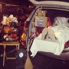 the trunk of a car is packed with items and decorations for halloween night, as well as skeleton figurines