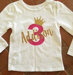 Are you ready for your little princess to turn 3 years old?? This pink and gold personalized birthday shirt will go with many different birthday party themes. Your three year old girl would like to have a personalized shirt her name on it for her 3rd birthday party coming up. All items are made in a smoke and animal free home. The shirt is a solid white with dark pink number 3 and a gold glitter crown and name. We can do any color combinations so or numbers if you do not see the colors you would Girls Birthday Outfit, Cow Print Dress, Summertime Outfits, Personalized Birthday Shirts, Glitter Crown, Western Clothing, Birthday Girl Outfit, Big Sister Shirt, Birthday Outfits