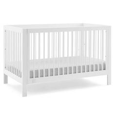 a white crib is shown against a white background with no sheets on the bed