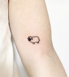 a small black sheep tattoo on the left arm and right arm with a white background