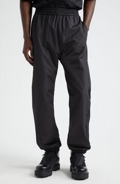 Tonal detailing keeps the look sleek and the branding subtle on these recycled-polyester track pants trimmed with piping and monogrammed with a 4G logo. 31" inseam; 10" leg opening; 13 1/2" front rise; 18" back rise (size 32) Elastic waist Front slant pockets; back welt pocket Elastic hems 100% recycled polyester Hand wash, dry flat Imported Designer Clothing Black Athleisure Pants With Logo Waistband, Welt Pocket, Track Pants, Piping, Givenchy, Designer Clothing, Elastic Waist, Track, Hand Wash