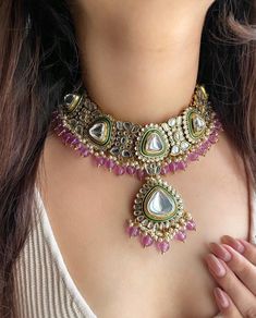 Adorn yourself in timeless elegance with this exquisite lavender purple Kundan and zircon necklace set, perfect for weddings and special occasions. Crafted with meticulous attention to detail, the set features delicate  hues reminiscent of Pakistani and Punjabi traditions, with a touch of Bollywood glamour. Complete with matching earrings and a stunning maangtika, this Indian Kundan ensemble effortlessly captures the essence of sophistication and grace. Measurements:   Necklace Length-14" Necklace Width- 11" Centre piece length -4" Earring Length-4" Each earring weighs:54 gms    Maangtika Length- 7" Maangtika Width- 1.5" Kundan Bridal Set, Punjabi Jewellery, Indian Wedding Jewellery, Bollywood Glamour, Zircon Necklace, Jewellery Indian, Set Earrings, Indian Wedding Jewelry, Cz Jewelry