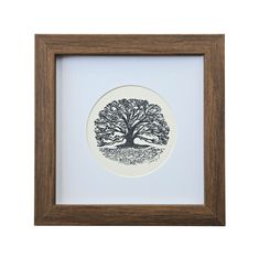 a black and white plate with a tree on it in a wooden framed box frame