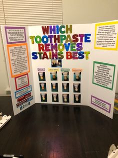 a table with a poster on it that says which toothpaste removes the stains best