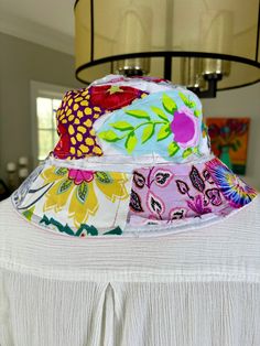 Super cute up-cycled floral bohemian, hippie, patchwork hat. This hat will take you everywhere! Whether you're golfing, gardening, boating, beach day, dancing at a festival or just chillin fishing, this is going to be your go to hat. I have made many and they are machine washable, that's is how you get them to FRAY! However, they will shrink a bit as the are 90% cotton. So best to hand wash and line dry. The circumference is 22.8inch. Foldable, easy to carry or pack inside your purse, tote or backpack. 90% Cotton, 10% Poly Hand wash gentle cycle and Line dry Multicolor Summer Hat For Garden Party, Multicolor Wide Brim Sun Hat For Garden Party, Bohemian Sun Hat For Outdoor Spring, Bohemian Sun Hat For Spring Outdoor Events, Bohemian Adjustable Sun Hat For Garden Party, Bohemian Sun Hat For Spring Outdoor, Hippie Spring Hats Adjustable Fit, Adjustable Bohemian Sun Hat For Garden Party, Hippie Spring Hats With Adjustable Fit