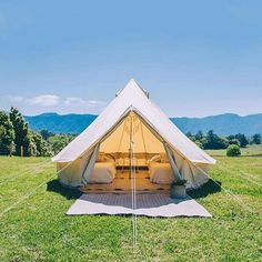 a tent set up in the middle of a field