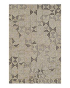 an area rug with various shapes and sizes on the floor, including triangles in grey