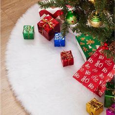 presents under the christmas tree are wrapped in red and green paper