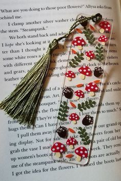 the bookmark is decorated with mushrooms and leaves