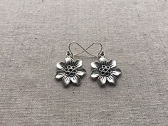 "Here are some pretty and fun silver plated flower earrings. They have wonderful detail and are lightweight and versatile. They measure 7/8\" across and hang from allergy free silver plated earwires. I have a matching necklace in my shop, if you would like the whole set." Silver Flower Earrings For Spring, Silver Flower Shaped Earrings For Spring, Sterling Silver Flower Charm Earrings, Spring Silver Flower Earrings Nickel Free, Spring Flower Earrings In Silver, Nickel-free, Spring Sterling Silver Earrings With Flower Charm, Spring Silver Flower Earrings, Nickel-free Silver Flower Earrings For Spring, Spring Silver Flower Shaped Earrings