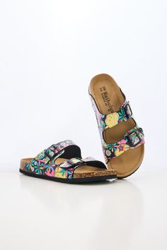 Introducing Maibulun's Signature Double Strap Footbed Sandal in tropical multi floral prints. Designed for ultimate comfort and style, these sandals feature a double strap design for secure support and a hard footbed for extra ankle support. Perfect for a day out or a casual stroll, elevate your look with these signature sandals. 0.59" inch heel Slip-on / buckle closure Hard Cushioned footbed Man-made leather upper Man-made lining EVA sole Multicolor Cushioned Slide Sandals, Multicolor Slides With Cushioned Footbed, Multicolor Open Toe Slides With Cushioned Footbed, Floral Print Round Toe Sandals For Vacation, Multicolor Slide Sandals With Cushioned Footbed, Adjustable Open Toe Multicolor Slides, Multicolor Slip-on Sandals With Textured Footbed, Multicolor Adjustable Strap Sandals, Multicolor Adjustable Sandals