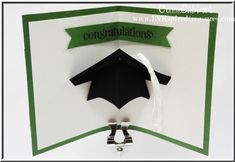 congratulations card with black graduation cap and tasseled ribbon hanging from it's corner