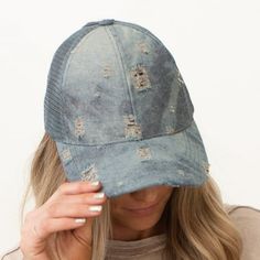 Take your look up a notch with this CC Destroyed Denim Pony Cap! It has everything a fashionable trendsetter needs, like an adjustable hook and loop hidden strap, distressed denim look, and of course, ponytail access in the back. Get the quality you want and the authenticity you deserve with Authentic CC branding! This hat won't just turn heads--it'll make 'em do double takes! Size: One Size.  Color: Blue.  Gender: female.  Age Group: adult. Adjustable Faded Distressed Hat, Trendy Washed Hat, One Size, Trendy Washed Hat One Size Fits Most, Trendy Washed Blue Hat, Trendy Washed Hat, Denim Snapback Baseball Cap For Spring, Distressed Blue Snapback Hat, Casual Distressed Adjustable Baseball Cap, Distressed Blue Hat With Adjustable Fit