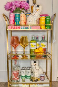 a gold bar cart filled with drinks and condiments