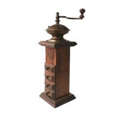 an old fashioned coffee grinder with wooden drawers and knobs on the front, against a white background