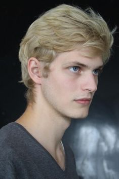 a young man with blonde hair and blue eyes