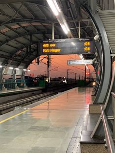 an empty train station with the lights on