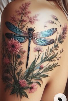 the back of a woman's shoulder with flowers and dragonflys on it