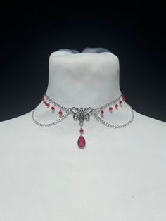 Succumb to the charm of this necklace combining Victorian style and art nouveau, adorned with a drop of blood pearl and delicate faceted pearls, inspired by the elegance of vampire legends. --------------------------- Chain 2 x 3 mm in stainless steel Glass drop bead 15 x 8 mm Small red faceted glass beads 3 mm Zinc alloy clasps and connectors Minimum length: 29 cm* Maximum length: 39 cm* ⚠ All my jewelry is assembled by hand Jewelry resistant to time provided you take care of it, avoid contact Silver Vampire Style Choker As Gift, Gothic Red Jewelry With Lobster Clasp, Red Gothic Jewelry With Lobster Clasp, Adjustable Red Gothic Jewelry, Red Ruby Choker Jewelry, Silver Vampire Style Choker Necklace, Red Ruby Victorian Necklace, Vintage Red Choker Jewelry, Red Vintage Choker Jewelry