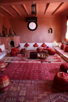 a living room filled with lots of furniture and rugs on top of a floor