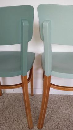 two chairs sitting next to each other in a room with carpeted flooring and walls