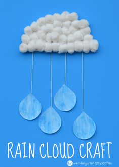 the clouds are made from cotton balls and water droplets hanging from strings on a blue background