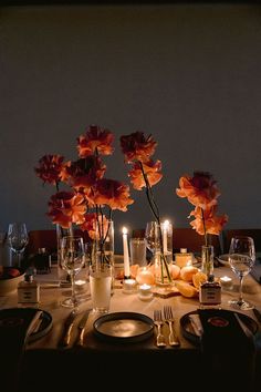 the table is set with candles and flowers