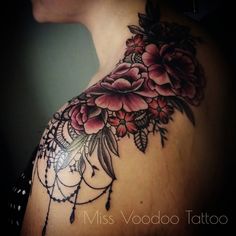 the back of a woman's shoulder with flowers on it