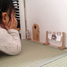 a woman sitting in front of a mirror with her hand on her face