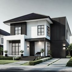 a white and black two story house with lots of windows