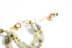 You are sure to set the stage for an evening to remember. Green drapes the unusual combination of two long strands of green prehnite , gold and Swarovski© crystal is a stunning addition to any outfit. It comes on an adjustable chain with large lobster claw clasp for a perfect fit. The crystal adds a subtle sparkle. Green Prehnite is an easygoing stone that works well with casual or dressy attire. Elegant Green Double Strand Jewelry, Gold Single Strand Jade Jewelry, Elegant Jewelry With Natural Stones And Chrysoprase, Elegant Chrysoprase Jewelry With Natural Stones, Elegant Faceted Chrysoprase Jewelry, Green Amethyst Jewelry With Natural Stones, Elegant Prehnite Gemstone Jewelry, Elegant Single Strand Chrysoprase Jewelry, Gold Prehnite Jewelry As A Gift