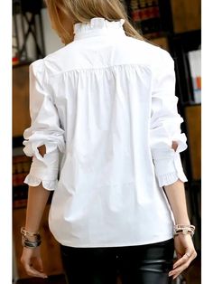 This re-imagined classic is nothing short of fabulous. It features a ruffle-neck details and sleeve band, comfortable loose fit, and 100% cotton! Color: White Fabric: 100% Cotton Chic Top With Button Cuffs And Ruffled Collar, Classic Cotton Blouse With Ruffles, Relaxed Fit Button-up Blouse With Ruffles, Cotton Top With Ruffled Collar, Cotton Tops With Ruffled Collar, Long Sleeve Ruffled Shirt With Relaxed Fit, Classic Cotton Top With Ruffled Collar, Casual Shirt With Ruffled Collar For Fall, Cotton Ruffle Button-up Tops