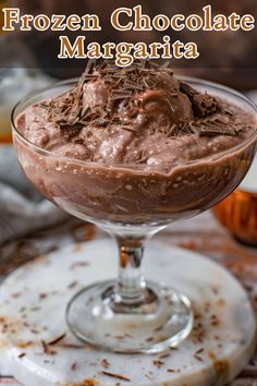 a chocolate dessert in a glass bowl with the words frozen chocolate margarita