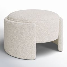 a white ottoman sitting on top of a table