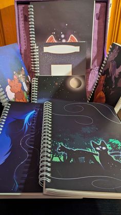 several notebooks are sitting on top of each other