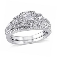 two pieces of white gold with diamonds on each side and an engagement ring in the middle